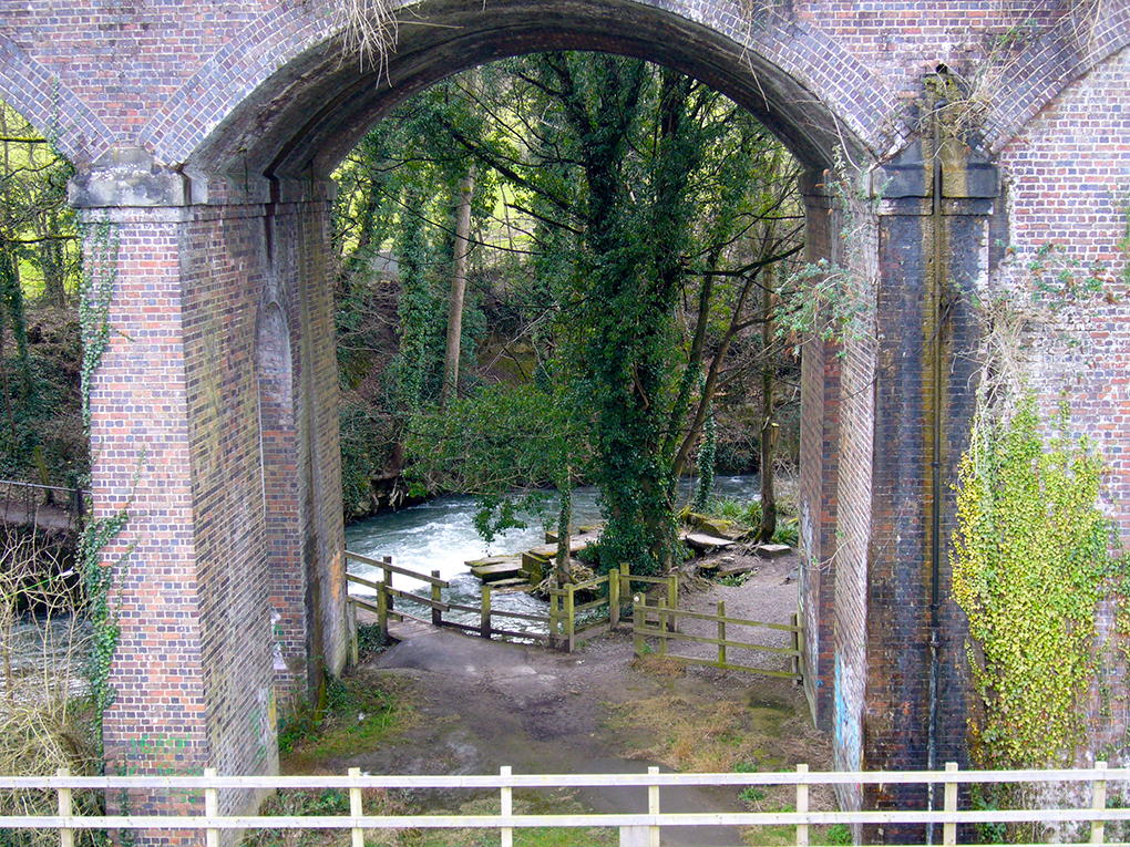 view of a river through railway arches