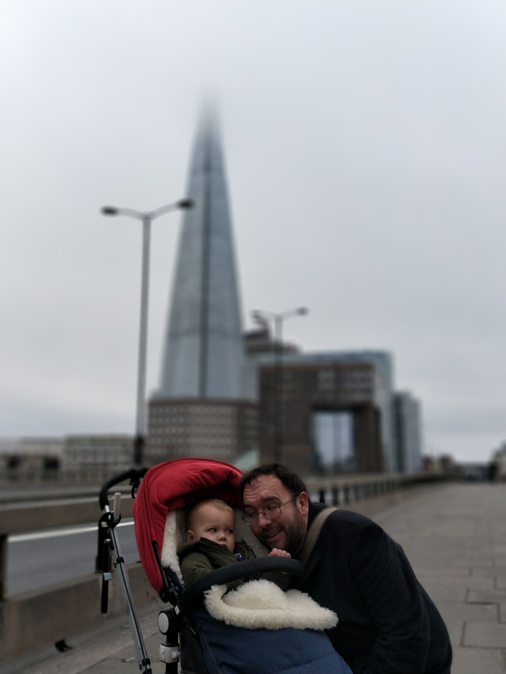 man and baby in front of the Shard