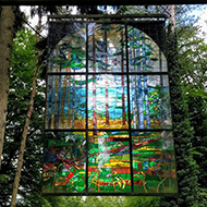 stained glass window hanging in forest