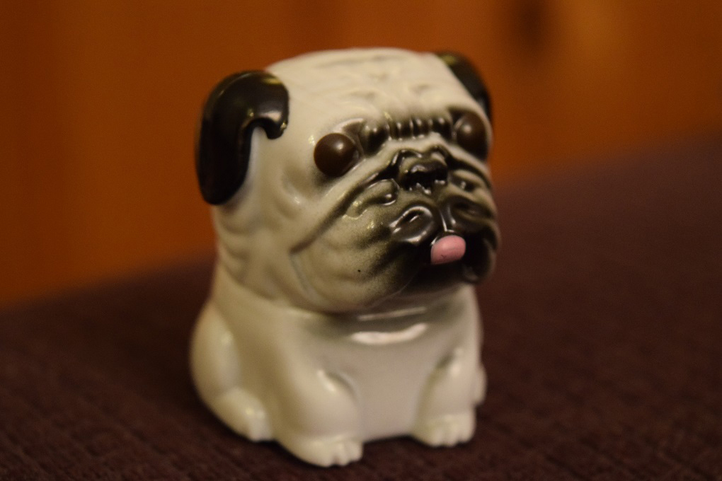 An extremely ugly plastic pug dog.