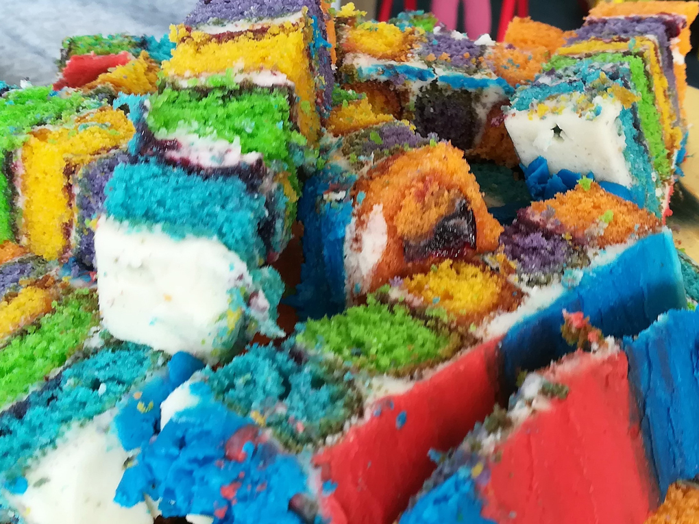 Slices of brightly coloured rainbow cake