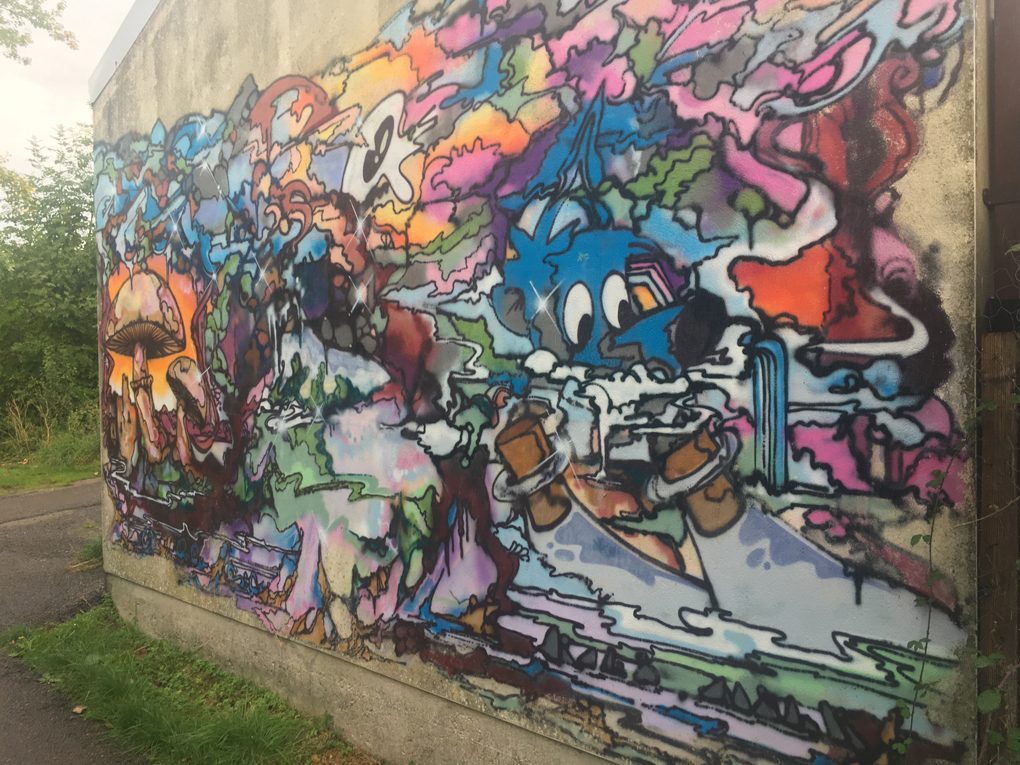 Colorful graffiti featuring a blue skinned character