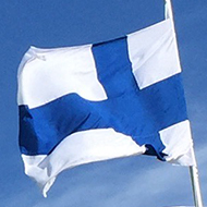 Finnish flags in a row outside a modern building