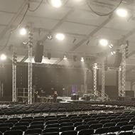 a large tent with empty seating and stage