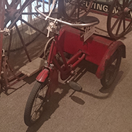A sweet collection of antiquarian bikes consisting of a Penny Farthing, a large Victorian tricycle with a huge front wheel, a child’s tricycle and a child’s scooter, nestled in a corner of the Athelstan Museum in the lovely old town of Malmesbury.