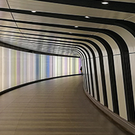 curved tunnel with walls lit up in various colours