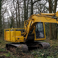 A yellow logging crane in a forest in Herefordshire.
