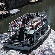 A double-decker passenger boat makes it way down the river in Bath