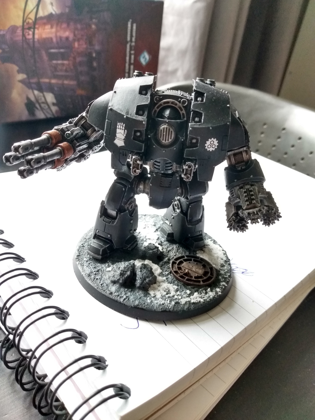 A warhammer miniature painted in the black of the Iron Hands legion
