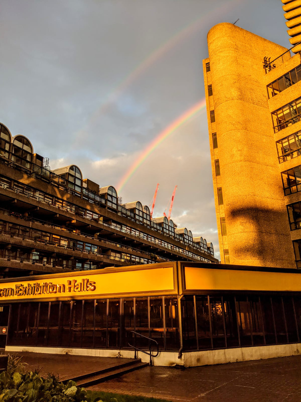 Double rainbow over Barbican exhibition and apartment buildings in central London
