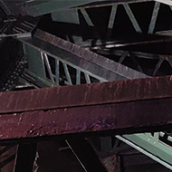 Looking up into the criss cross of structural steel supporting the Tyne Bridge in Newcastle