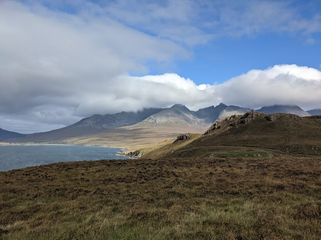 A view of the ocean, beach and mountains of Skye.