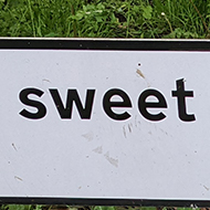 A road sign on a roundabout with the message 