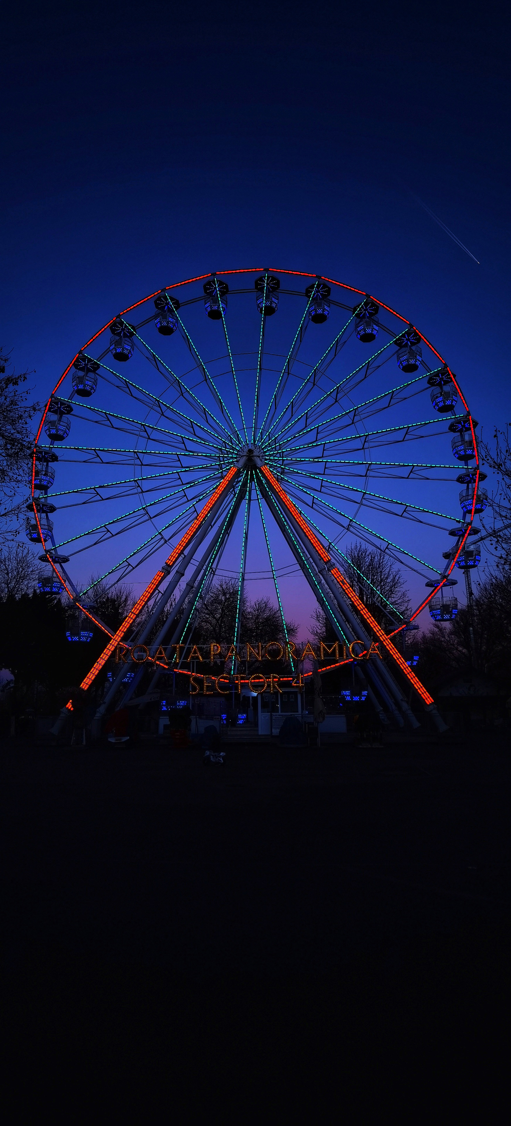 Lit up Ferris wheel in night sky