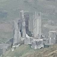 We see Corfe Castle emerge from the mist in the distance on a walk across the hills from Swanage