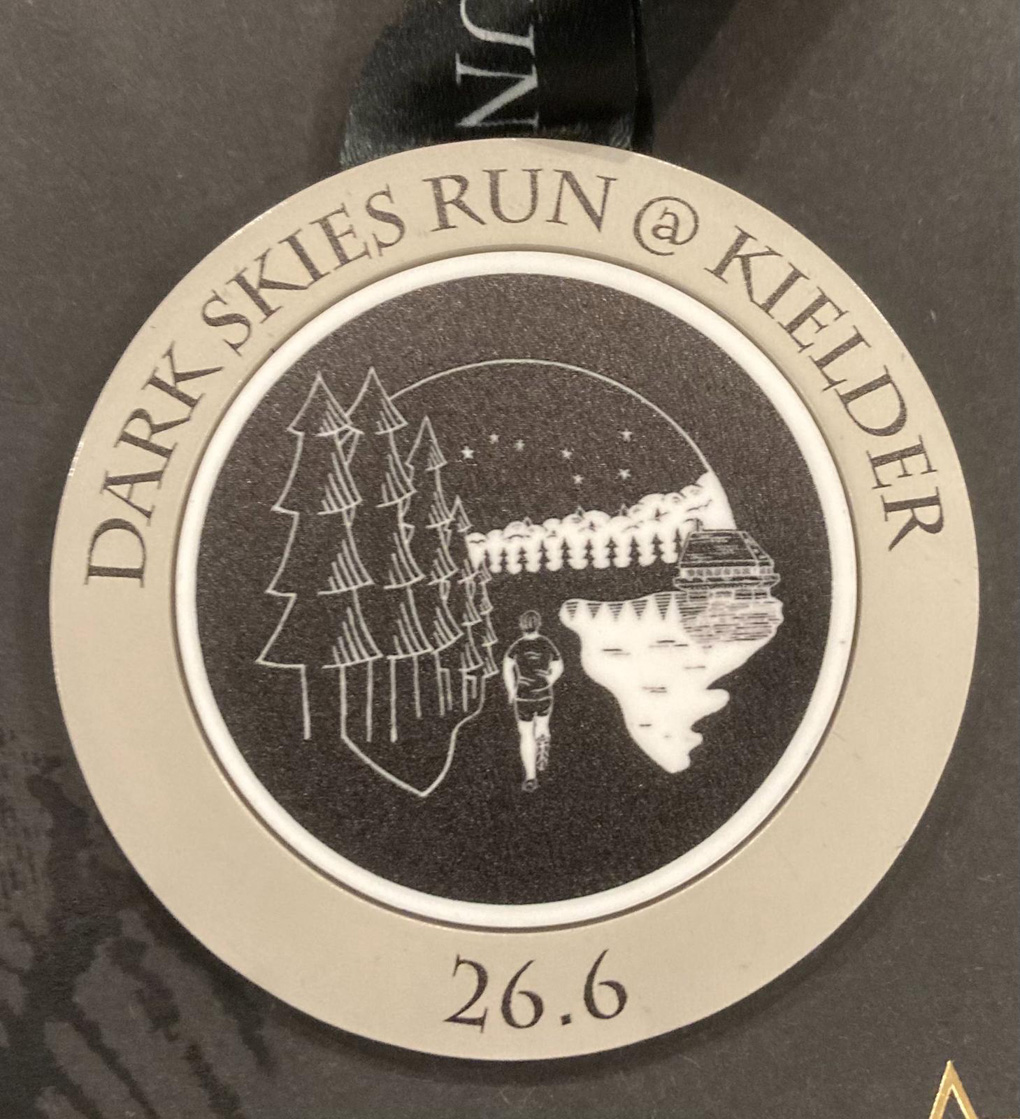 Medal for a night run reading Dark Skies Run Kielder