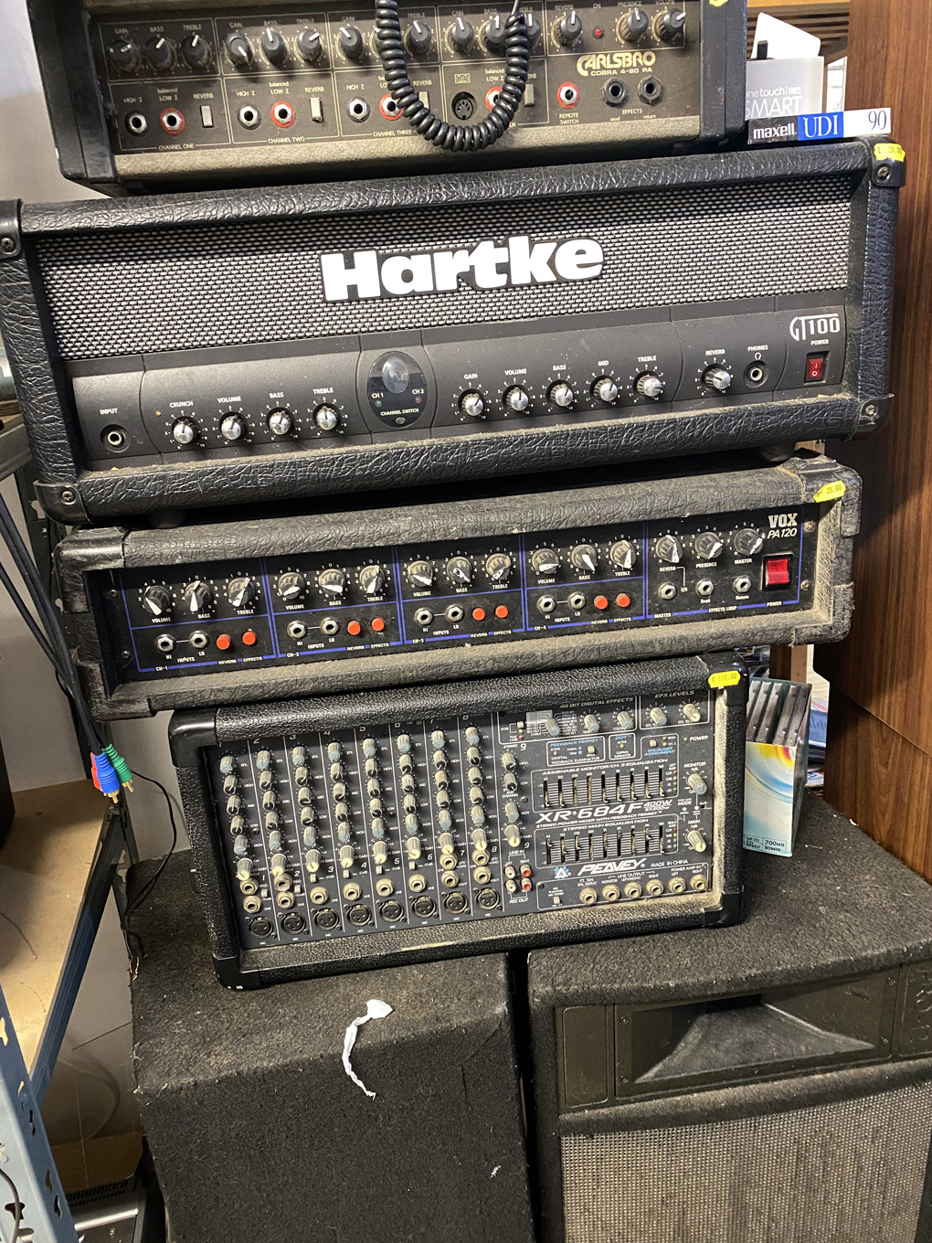A stack of old, dusty stage PAs and mixer amps