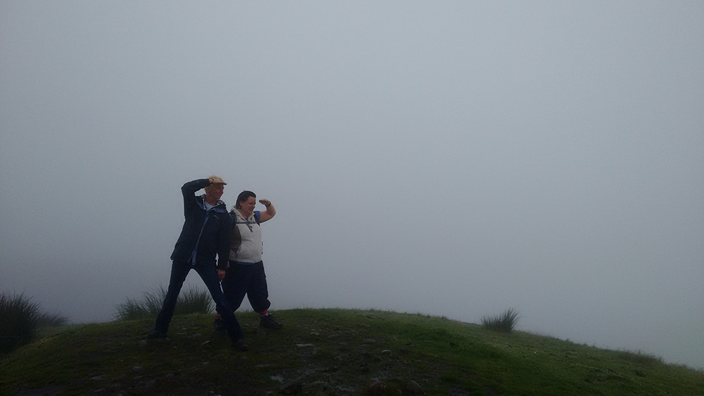 two people on a windy hill