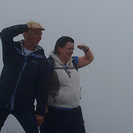 two people on a windy hill