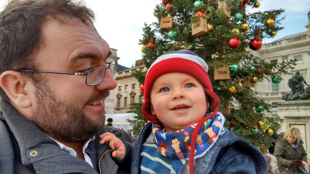 baby in cold weather clothing with father