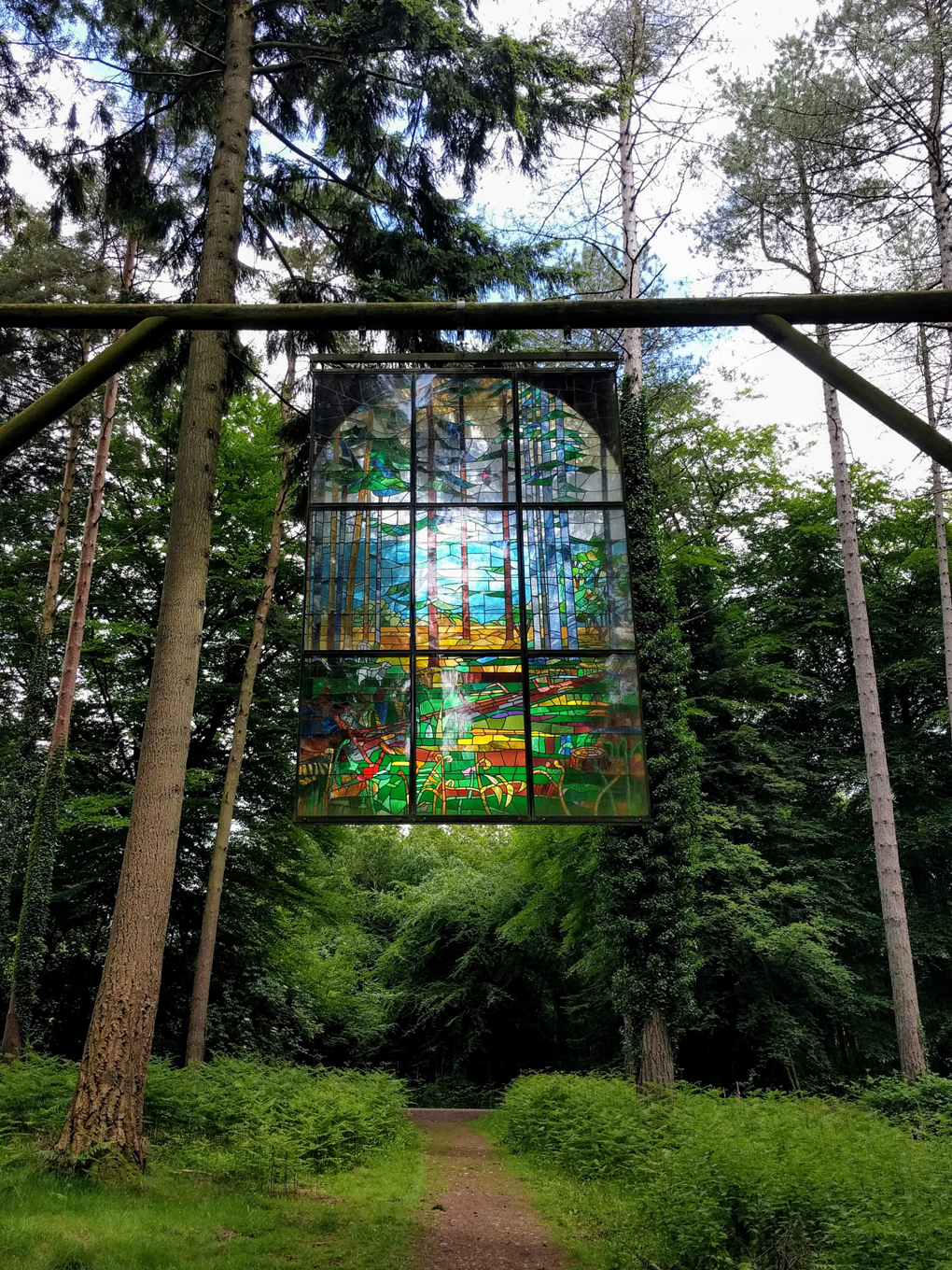 stained glass window hanging in forest