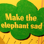 sign reading make the elephant sad