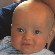 man drinking wine with baby