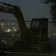 digger in the dark framed by trees