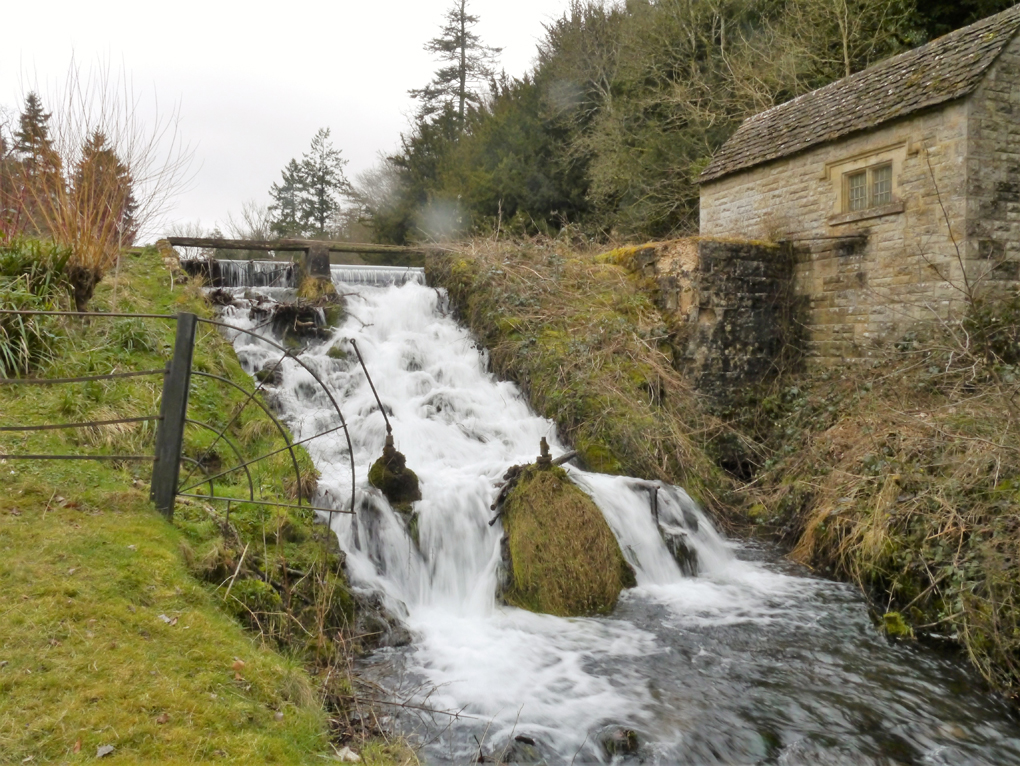 small waterfall by a house