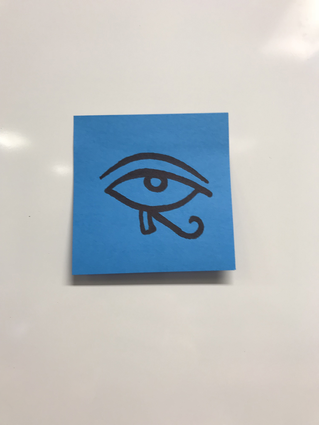 the eye of horus drawn on a postit note