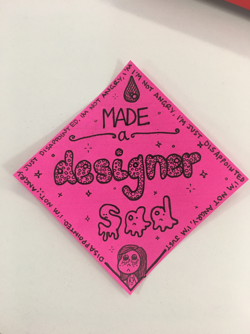 a badge made out of a post-it commemorating the achievement of disappointing a designer. It reads 