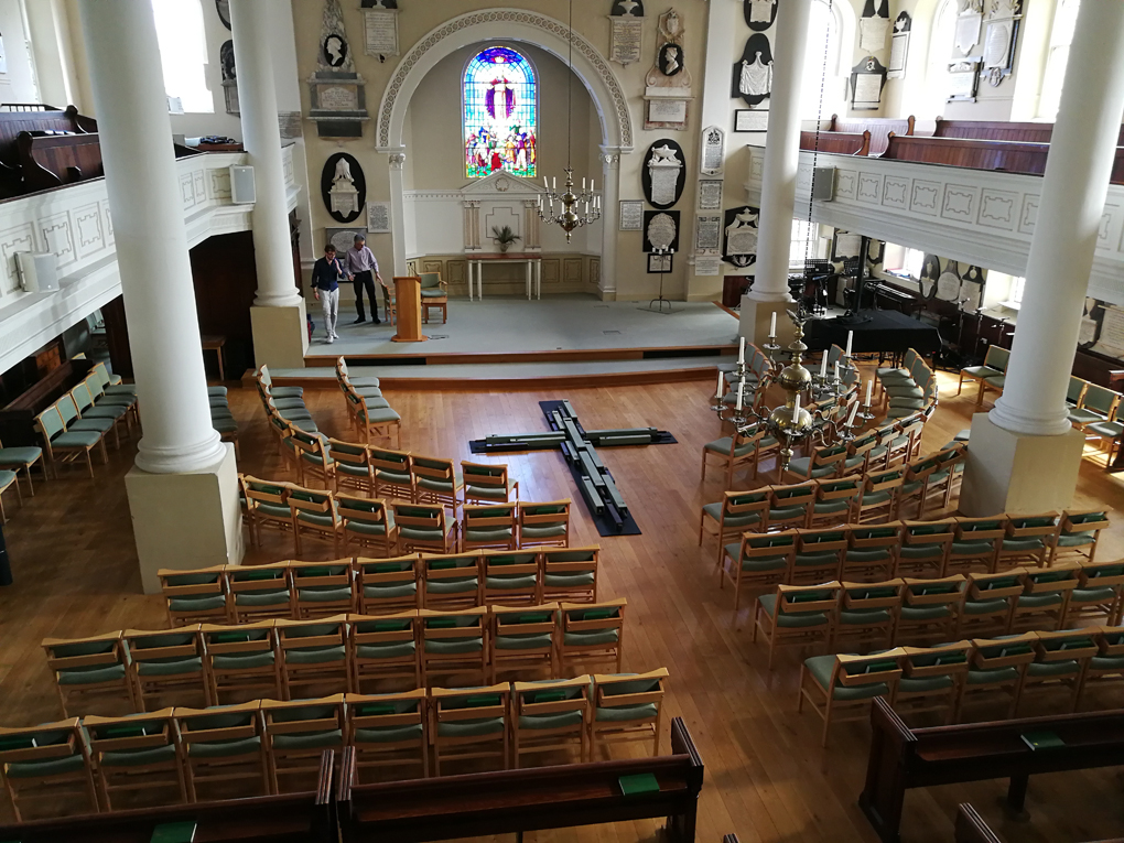 interior of a church with wooden cross before the altar