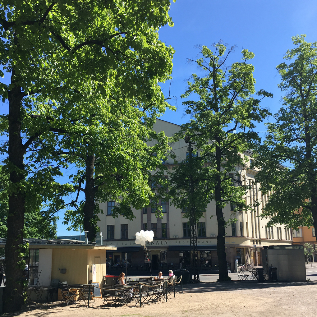 Beige building behind trees