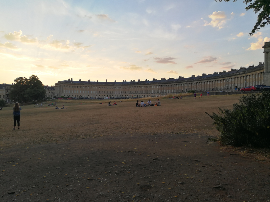 big Georgian building with all the grass in front dead and brown in the sun