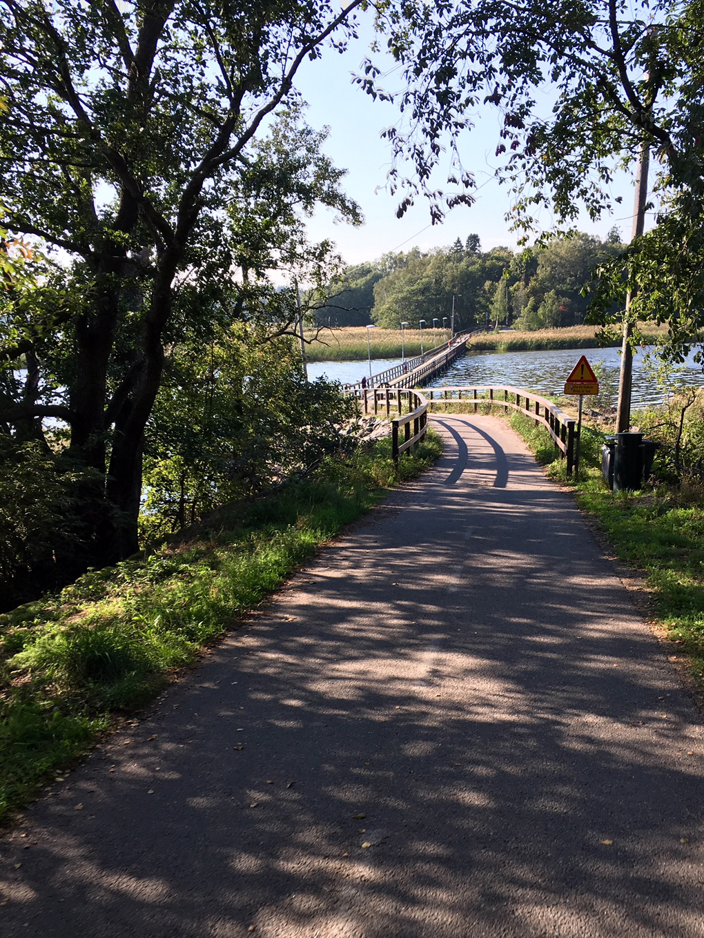 Small road and a bridge by the water.