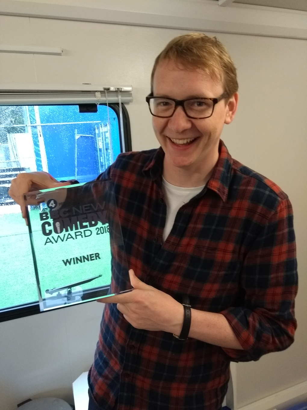 man posing with a trophy