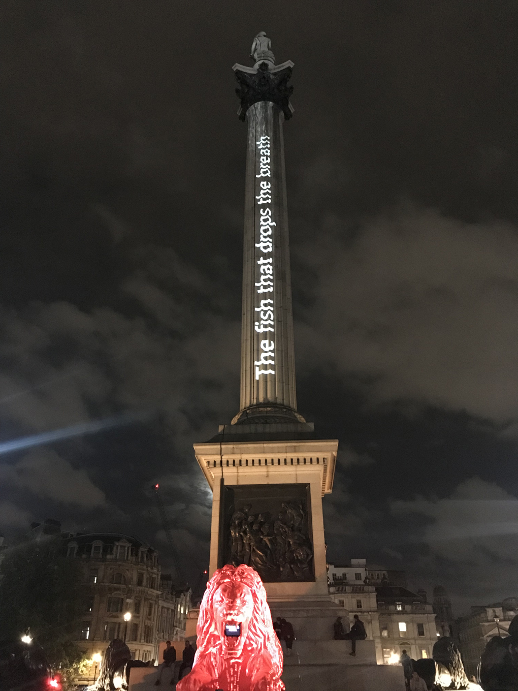 A line of poetry projected on to Nelson’s Column in London