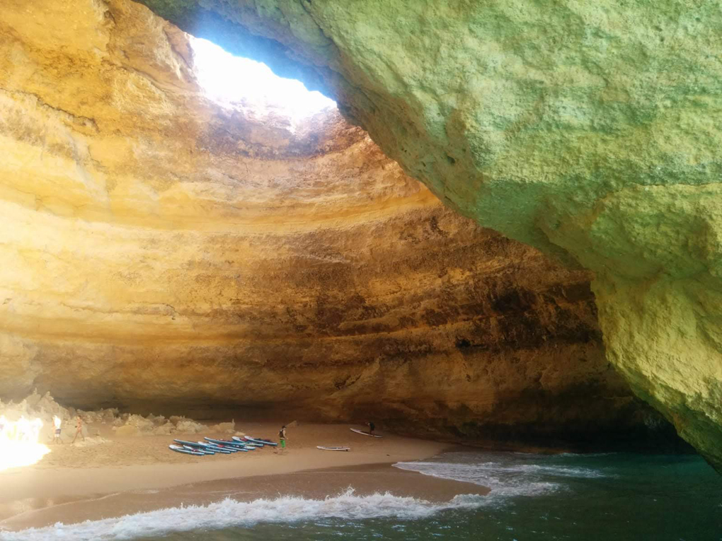 This is a picture of a sea cave in the Algarve near Lagoa. It shows the sun coming through a hole in the ceiling