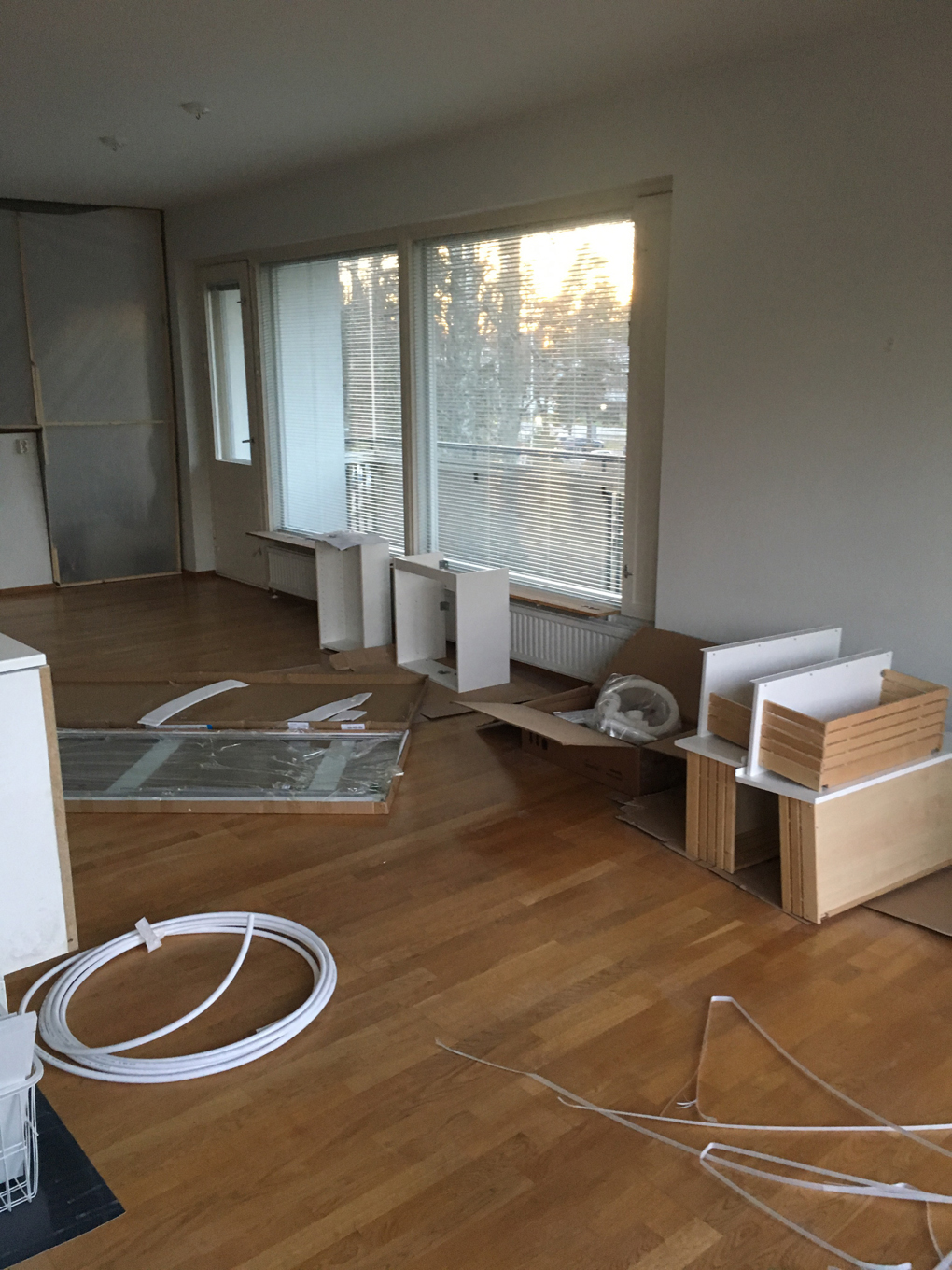 Empty room with half-assembled pieces of furniture.