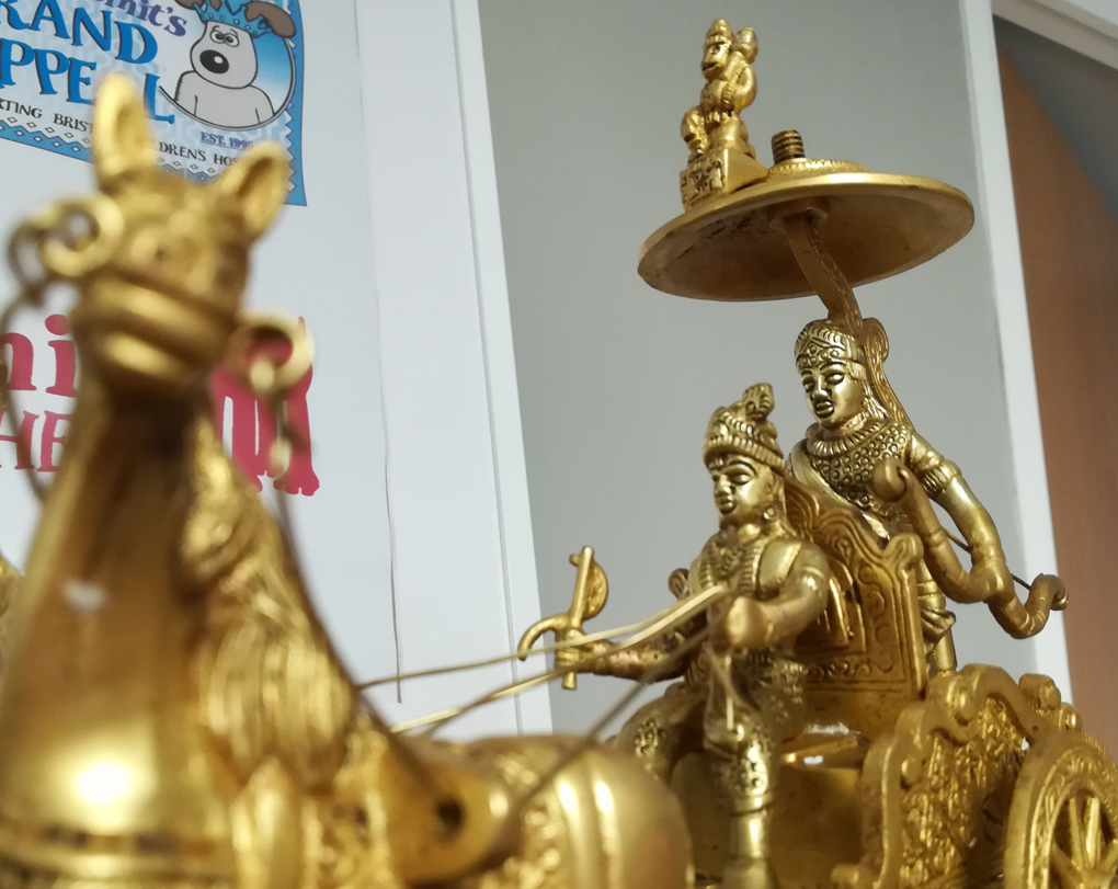 A golden statue of what I assume is Krishna, Arjuna and Hanuman, from the Mahabharata.