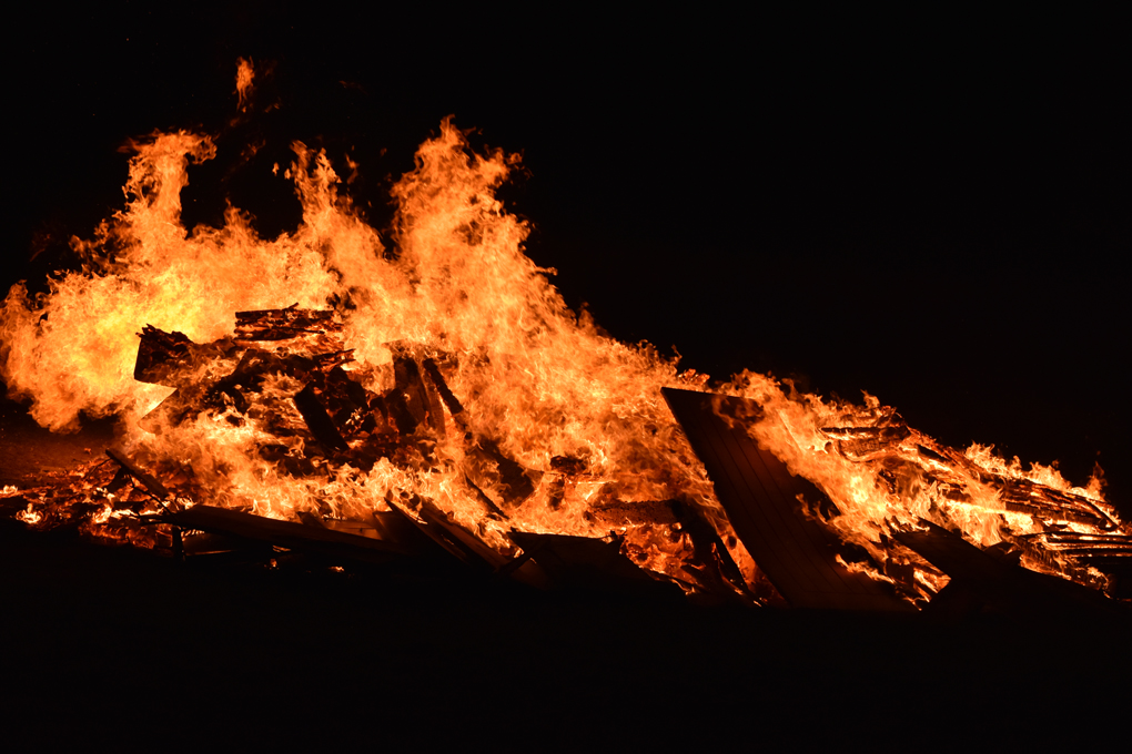 the heart of a bonfire with a wooden door refusing to burn