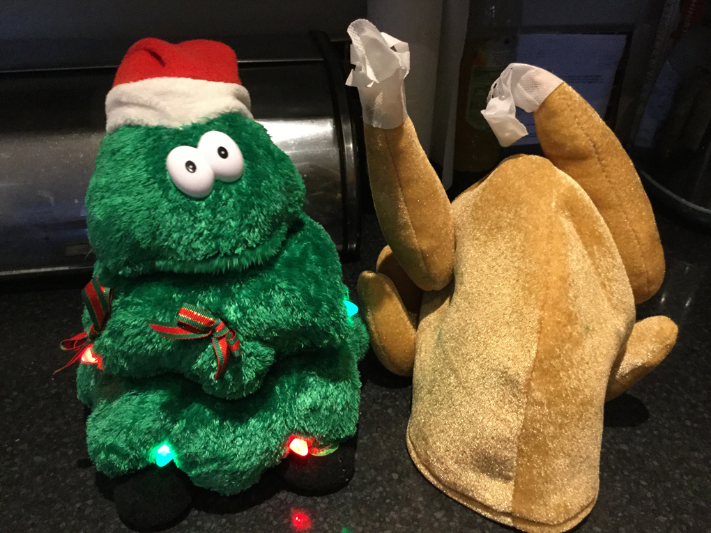 A picture of two pieces of junk - a green singing christmas tree and a hat that looks like a cooked turkey