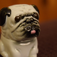 An extremely ugly plastic pug dog.