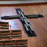 interior of a church with wooden cross before the altar