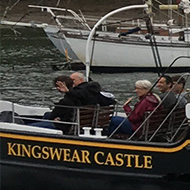 An old steam powered paddle boat traveling up the River Dart from Dartmouth