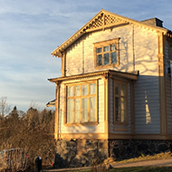 Yellow wooden building on a hill