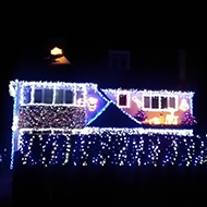 A house and garden lit entirely by fairy lights