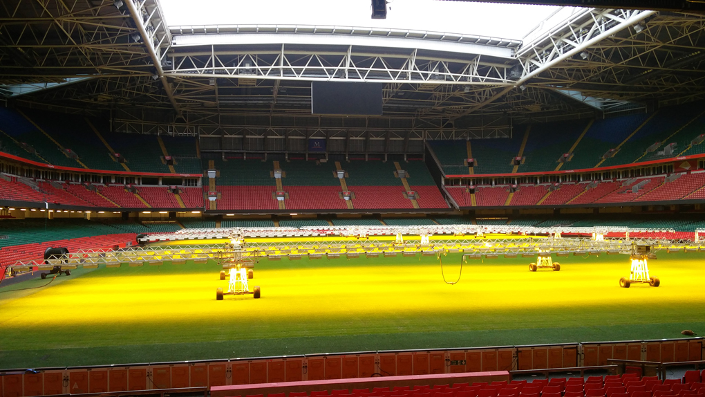The pitch of the Principality Stadium in Cardiff, covered in bright lamps, pointed at the grass, presumably to aid growth.