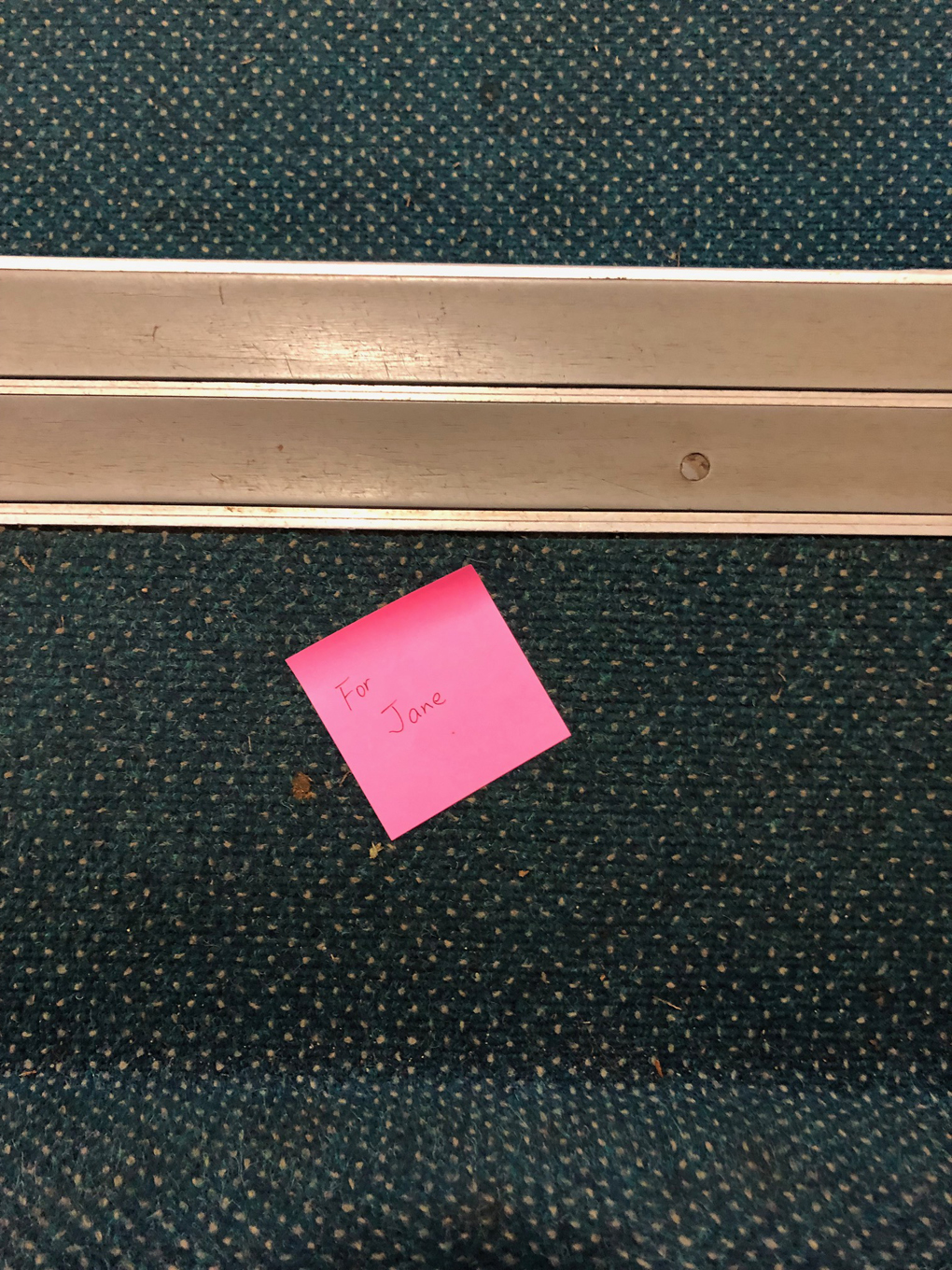 A pink post it note with the words For Jane written on it