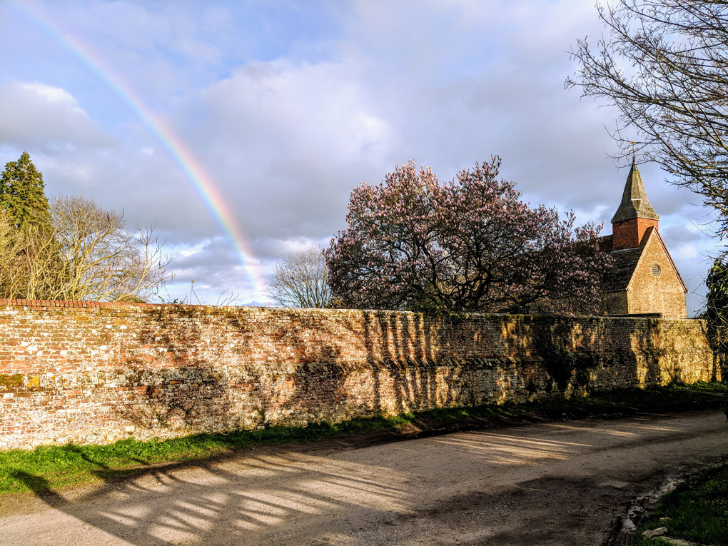 Church with rainbow in sky